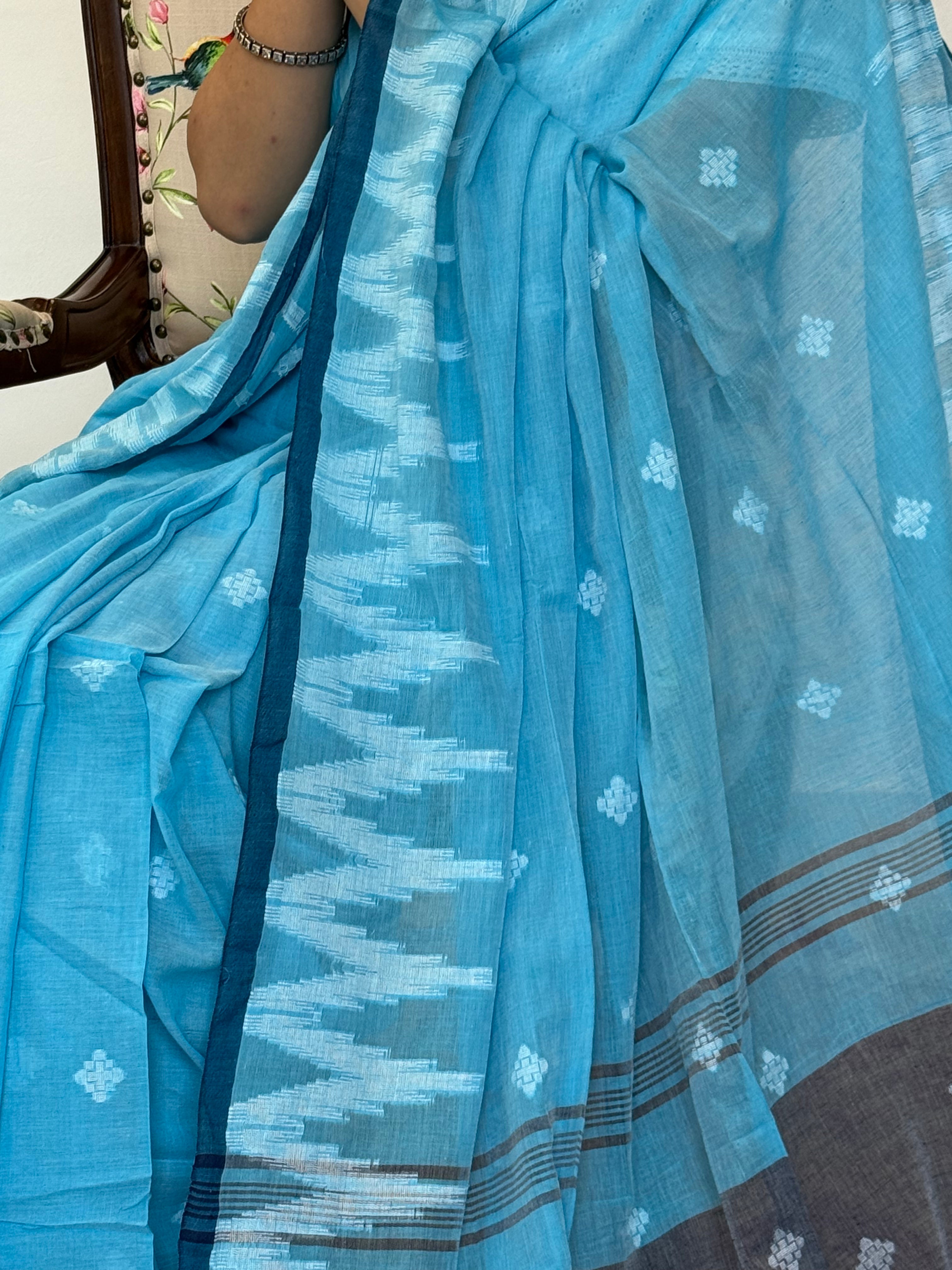 Elegant sky blue Bengal cotton saree styled for office or casual wear
Sky blue cotton saree showing border weaving and buti design