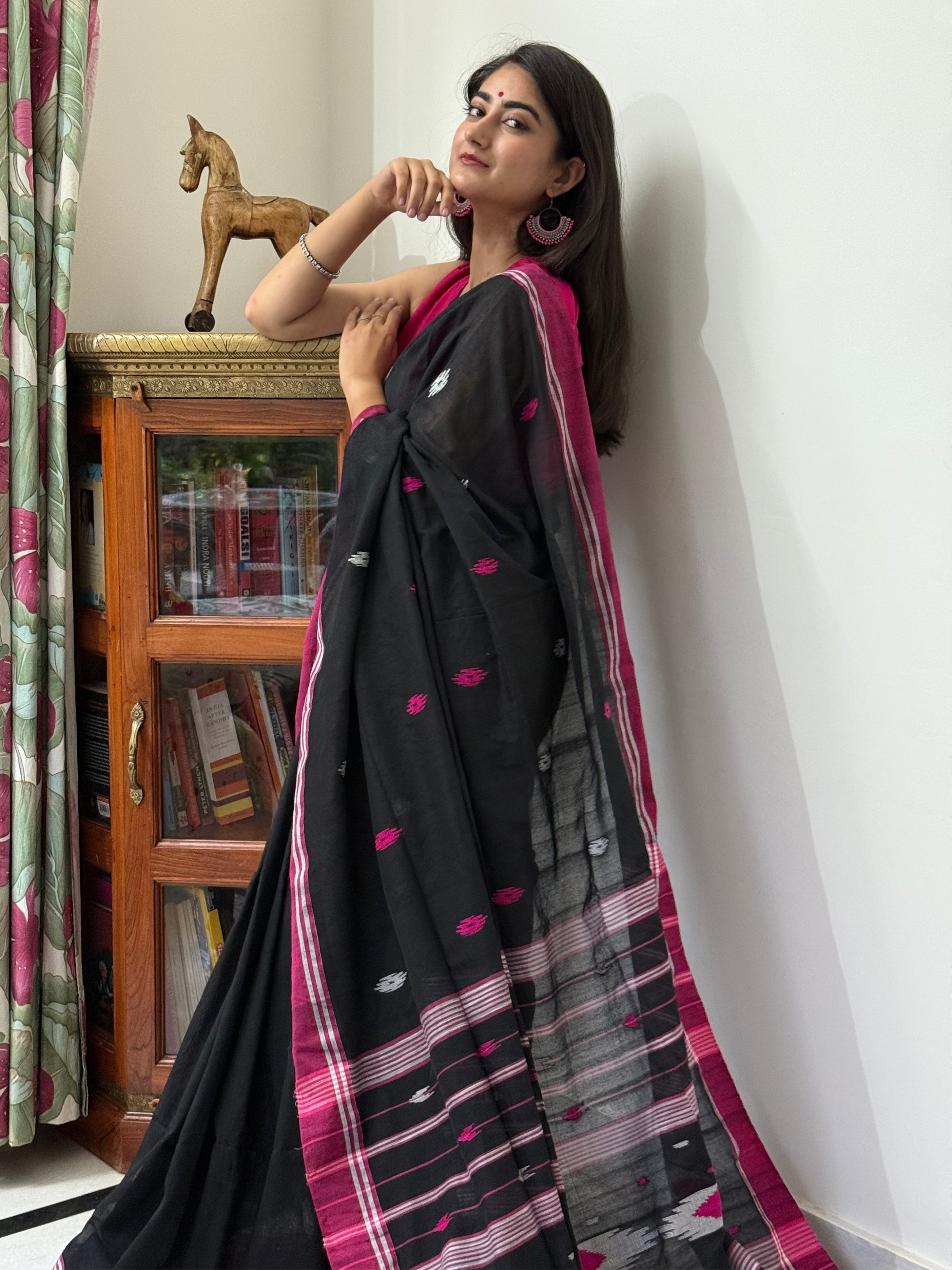 Black cotton saree featuring white-pink buti motifs and pink border