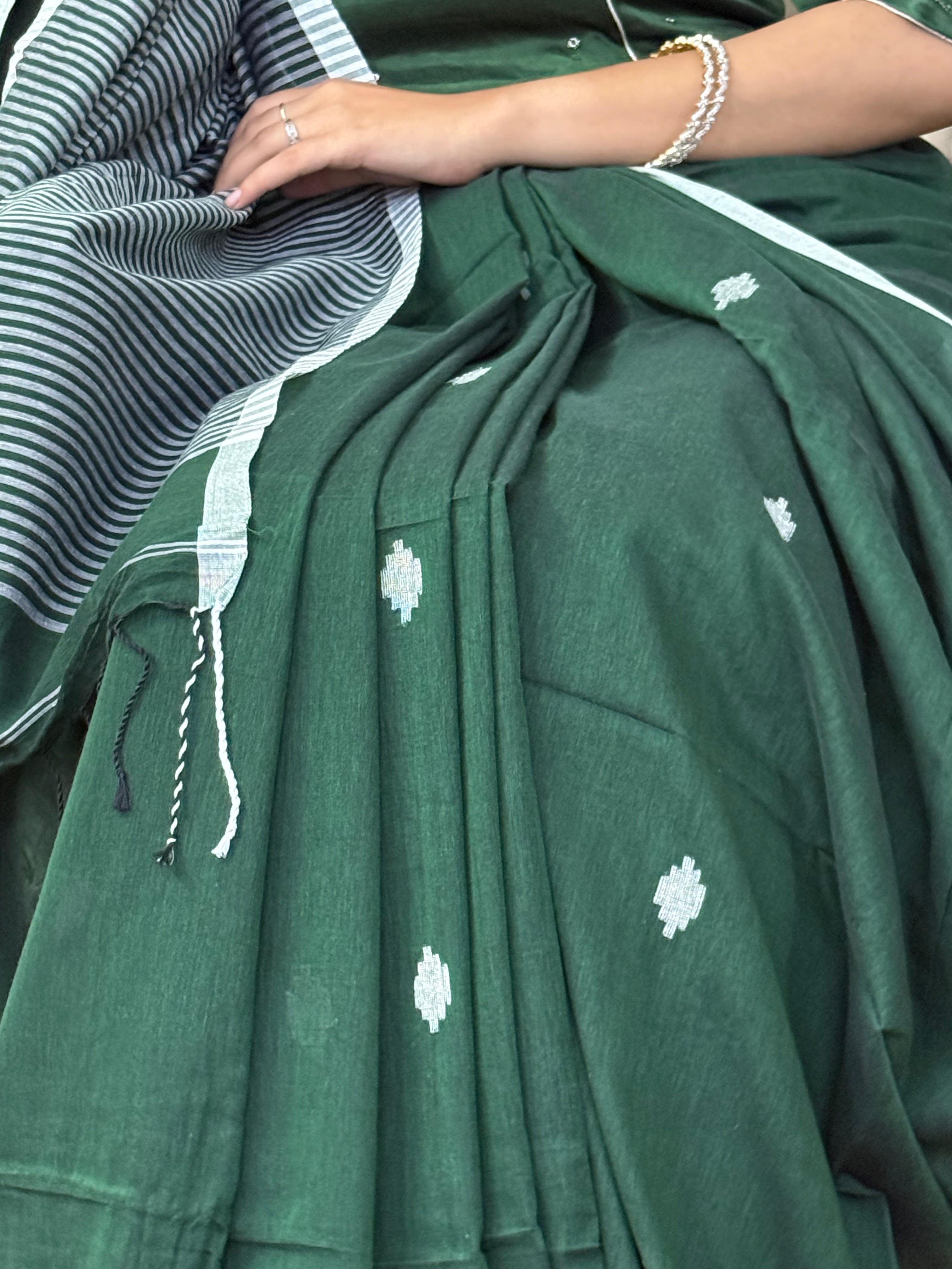 Elegant green and white cotton saree styled for office or casual wear
Green pure cotton saree with white buti and striped border design