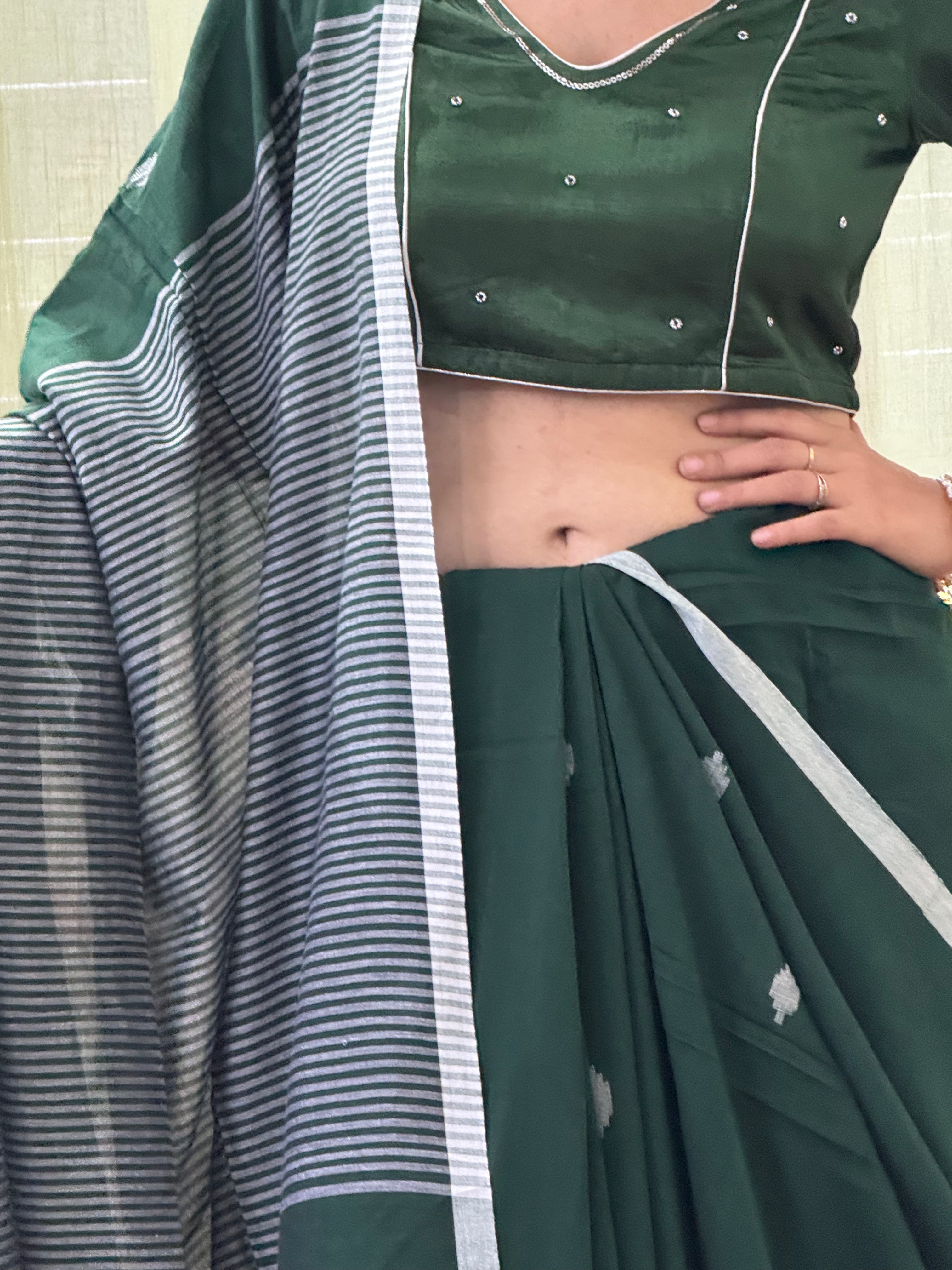 White buti motifs and stripe border on green cotton fabric
